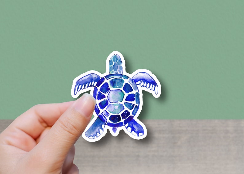 May include: A blue and purple watercolor sea turtle sticker. The turtle has a detailed shell and flippers.