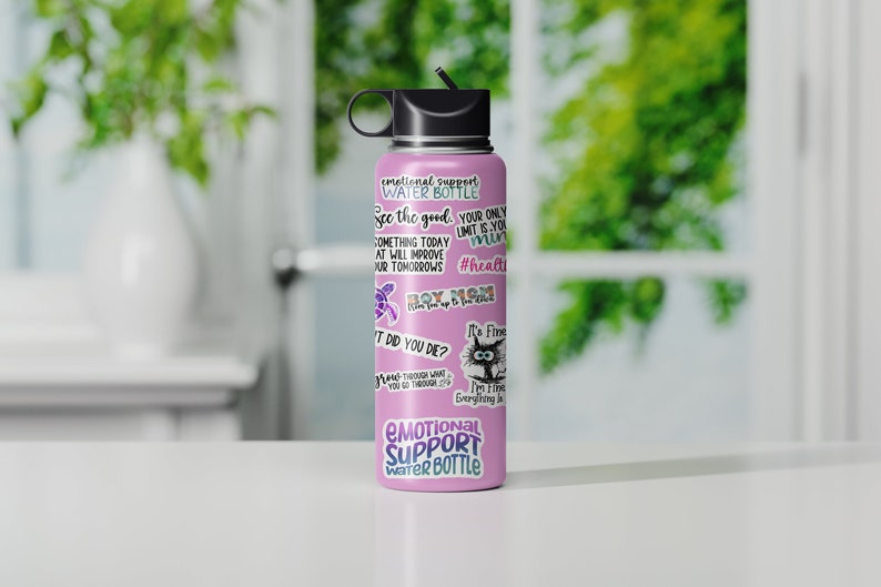 May include: Pink stainless steel water bottle with a black lid and a straw. The bottle is covered in stickers with motivational quotes and images. The text on the bottle reads "Emotional Support Water Bottle", "See the good, your only limit is your mind", "Something today at will improve your tomorrows", "#health", "Boy Mom", "It's fine", "I'm fine, everything is fine", and "It did you die?"