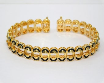 Pulsera de tenis vintage JOAN RIVERS con esmalte negro y tono dorado intercambiable.