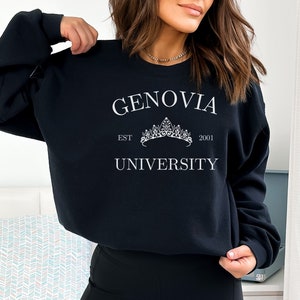 May include: Black sweatshirt with white text that reads "Genovia University" with a crown graphic and the text "EST 2001".