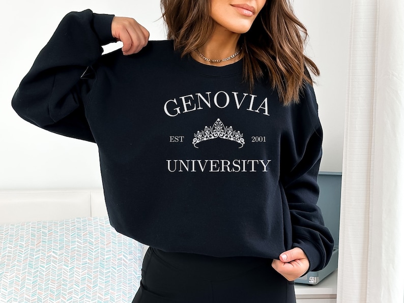 May include: Black sweatshirt with white text that reads "Genovia University" with a crown graphic and the text "EST 2001".