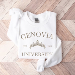 May include: White sweatshirt with the text "GENOVIA UNIVERSITY" in brown lettering. A crown graphic is above the text with "EST 2001" below it.