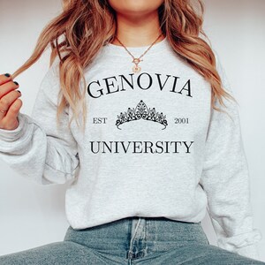 May include: A grey sweatshirt with the text "GENOVIA UNIVERSITY" and a crown graphic. The text "EST 2001" is below the crown.