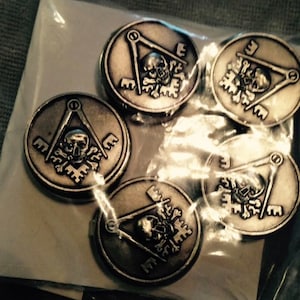May include: Five silver-toned metal buttons with a skull and crossbones design. The buttons feature a compass and square, and the letter "E" is visible on each button.