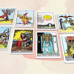 May include: A collection of tarot cards featuring colorful illustrations. The cards depict various scenes with figures, symbols, and text, including "Queen of Pentacles" and "The High Priestess." The cards are arranged on a light pink and white background.