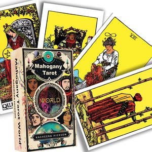 May include: A deck of "Mahogany Tarot" cards with a box featuring the word "WORLD" and illustrations of faces. Several tarot cards are fanned out, each with yellow backgrounds and colorful illustrations. The deck is by Kasheera Hickson.