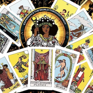May include: A collection of tarot cards with colorful illustrations. The central card features a woman with a crown and scepter, surrounded by a golden wheel. Other cards display figures and symbols, with text including "JUSTICE" and "WORLD."