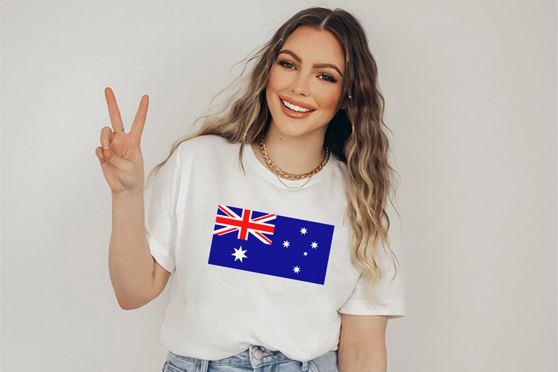 May include: White t-shirt featuring the Australian flag, a blue rectangle with the Union Jack in the upper left corner and white stars. The shirt is a casual style.