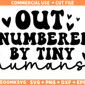 May include: Black and white graphic design with the text "OUT NUMBERED BY TINY humans" in a retro font. The text is surrounded by small hearts.