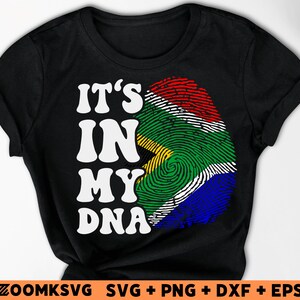 Pu&ograve; includere: Maglietta nera con una grafica bianca che dice "It's in my DNA" e un design di impronta digitale con i colori della bandiera sudafricana.