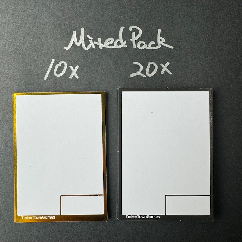 May include: Two blank card templates, one with a gold border and the other with a black border. The text "Mixed Pack" is written in white above the cards. The text "10x" is written in white to the left of the gold card and the text "20x" is written in white to the right of the black card. The text "TinkerTownGames" is written in white at the bottom of each card.