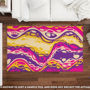 May include: Abstract area rug with a colorful design of yellow, pink, purple, and white swirls and circles. The rug is on a wooden floor.