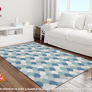 May include: A blue and white patterned area rug with a scale-like design. The rug is on a wooden floor in a living room setting with a white sofa and a white cabinet.