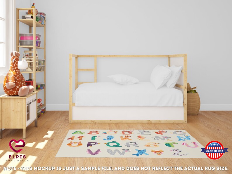May include: A white and beige alphabet rug with colorful animal illustrations and letters. The rug is in a child's bedroom with a wooden bed and a bookshelf.