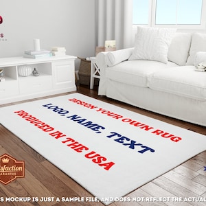 May include: A white rectangular rug with the text "DESIGN YOUR OWN RUG, LOGO, NAME, TEXT, PRODUCED IN THE USA" in red and blue. The rug is in a living room setting with a white sofa and wooden floor.