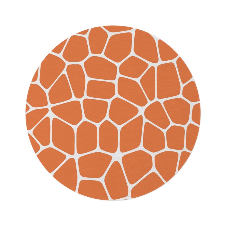 May include: A round orange and white patterned rug with a geometric design.