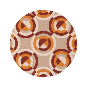 May include: A round rug with a geometric pattern of overlapping circles in shades of brown, orange, and white.