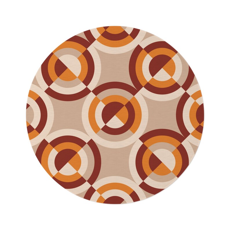 May include: A round rug with a geometric pattern of overlapping circles in shades of brown, orange, and white.