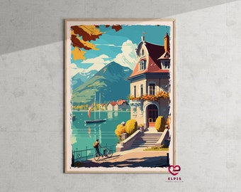 May include: A vintage-style travel poster featuring a colourful illustration of a house with a red roof, a lake, and a person riding a bicycle. The poster has a blue sky with white clouds and a mountain range in the background.