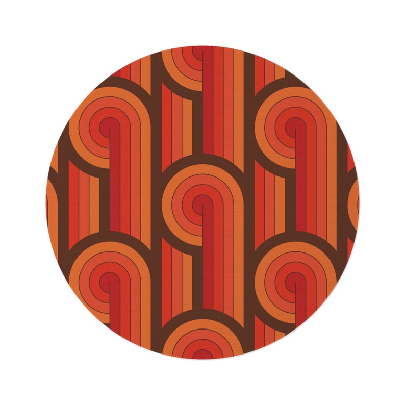 May include: A circular pattern with a retro 70s design. The pattern features curved lines in shades of orange, red, and brown.