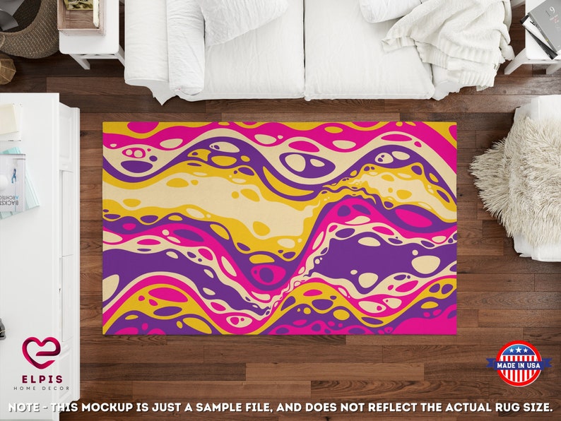 May include: Abstract area rug with a colorful design of yellow, pink, purple, and white swirls and circles. The rug is on a wooden floor.