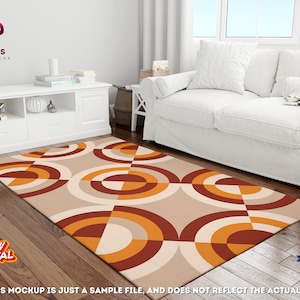 May include: A geometric patterned rug with orange, brown, and white circles and squares on a beige background. The rug is laid out on a wooden floor in a living room setting.