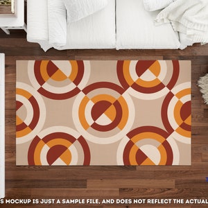 May include: A beige area rug with a geometric pattern of overlapping circles in shades of orange, red, and white.