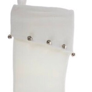 May include: White Christmas stocking with silver bells around the cuff.