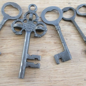 Old vintage victorian style ornate fancy rustic old cast iron garden decorative ornamental door hanging keys