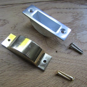 May include: Two metal door stop plates, one silver and one gold, with two screws.