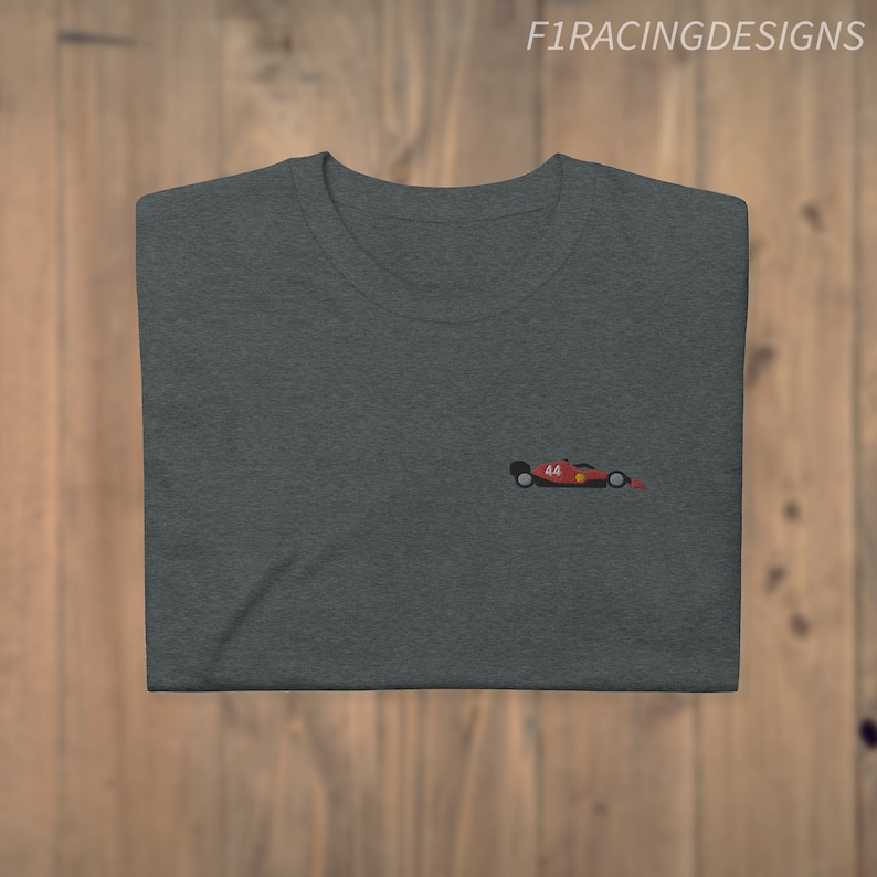 May include: A dark grey t-shirt with a small embroidered image of a red racing car with the number 44 on the side.