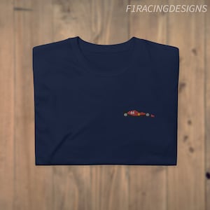 May include: A navy blue t-shirt with a small embroidered image of a red racing car with the number 44 on it.