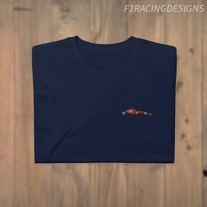May include: A navy blue t-shirt with a small embroidered image of a red racing car with the number 44 on it.