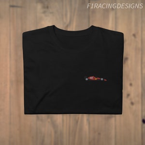 May include: Black t-shirt with a small red and black race car graphic on the left chest. The car has the number 44 on it.