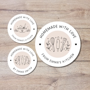 May include: Three round white stickers with black text and illustrations. The stickers say "Homemade with love" and feature kitchen tools like a whisk, rolling pin, and spatula. One sticker says "From Emma's Kitchen", another says "By Emma Smith", and the third says "Homemade with love" with a bowl and spoon.