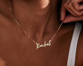 May include: A gold chain necklace with the name "Rachel" written in cursive script.