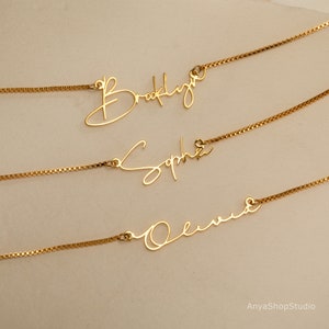 May include: Three gold necklaces with personalised names, Brooklyn, Sophia, and Olivia, written in a cursive script.