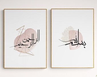 May include: Two framed prints with Arabic calligraphy in black on a white background. The calligraphy is surrounded by a pink watercolor wash and gold geometric shapes. The prints are hanging on a white wall above a pink armchair and a round wooden table with a white pitcher and cup.