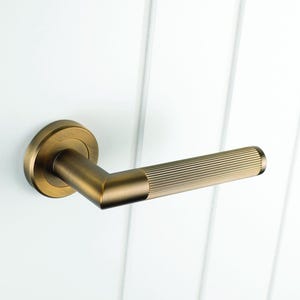 Lines Lever on Round Rose Door Handle. Pair of door handles on concealed rose perfect contemporary design. Ribbed for extra grip