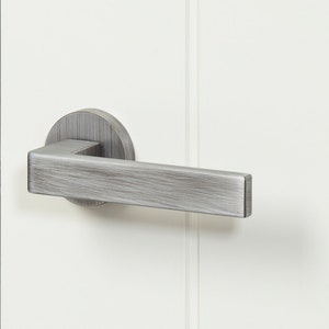 Pair of Door handles .Modern straight square face with a well sprung lever with a minimalist round rose, contemporary feel modern or urban
