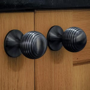 May include: A rustic wooden sign with the text "Welcome to our home" in white lettering. The sign features a distressed finish and a simple, inviting design, perfect for entryway decor.