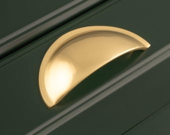 Elegant komgreep van massief messing, perfect voor traditionele of strakke moderne keukens of lades. Halfronde komgreep met bevestiging aan de achterzijde.