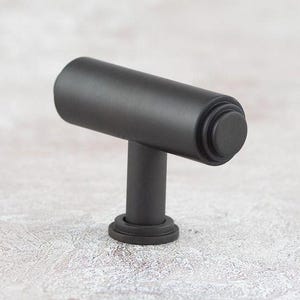 Stepped T-Bar Knob features a unique stepped design with rimmed detailing on the smooth face and circular rose, made from high-quality Brass