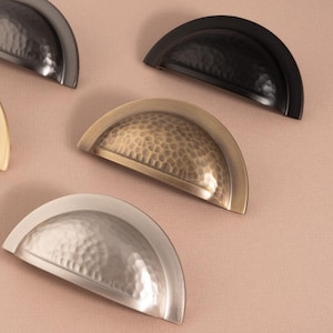 This Hammered ridged cup pull combines artisan texture with durable brass construction, adding charm and tactile depth to your cabinet, draw