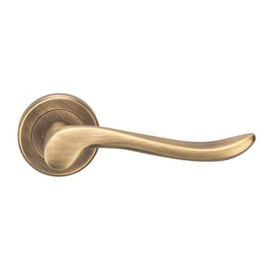 May include: A brushed antique brass door handle with a curved lever and a round base.