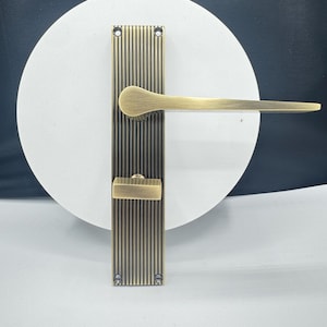 High end solid brass Pair of slim modern door handles on a Reeded / lined  back plate, available passage , dummy , privacy or key lock