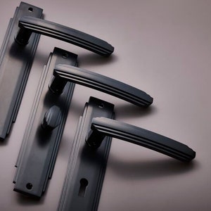 Pair of Art deco Door lever handles on back plate, passage , dummy , privacy or locking available, black , polished chrome or satin nickel