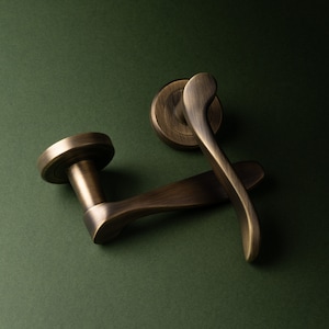 Verdum Lever On Rose, A pair of door handles classic scroll lever , curved smooth and nice in the hand , on round rose