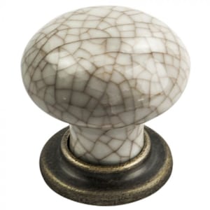May include: White ceramic cabinet knob with a crackled glaze finish and a bronze base.