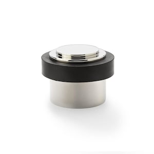 May include: A chrome doorstop with a black rubber base. The doorstop has a rounded top and a cylindrical base.